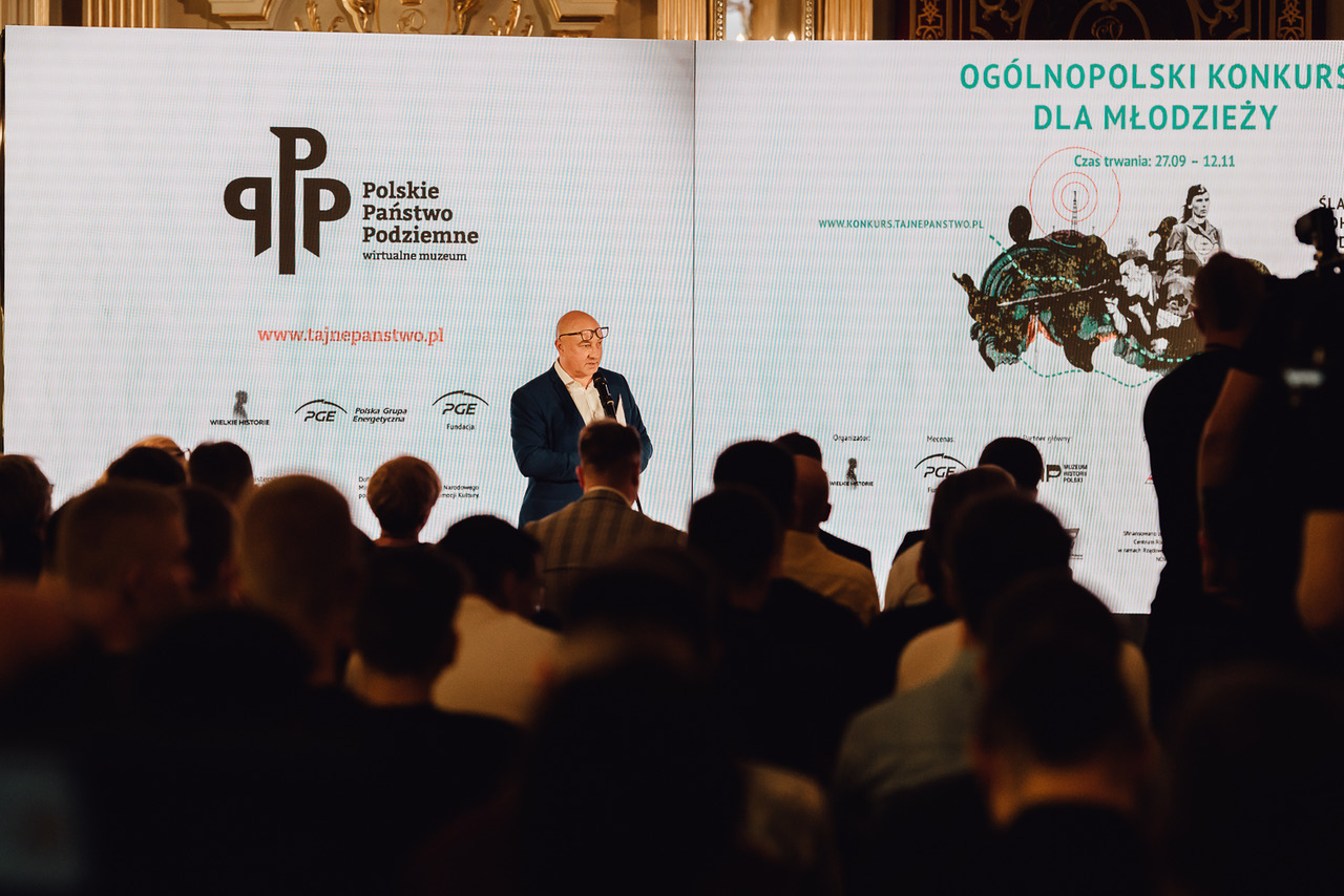 Publiczne wydarzenie poświęcone historii z dużą sceną i ekranem